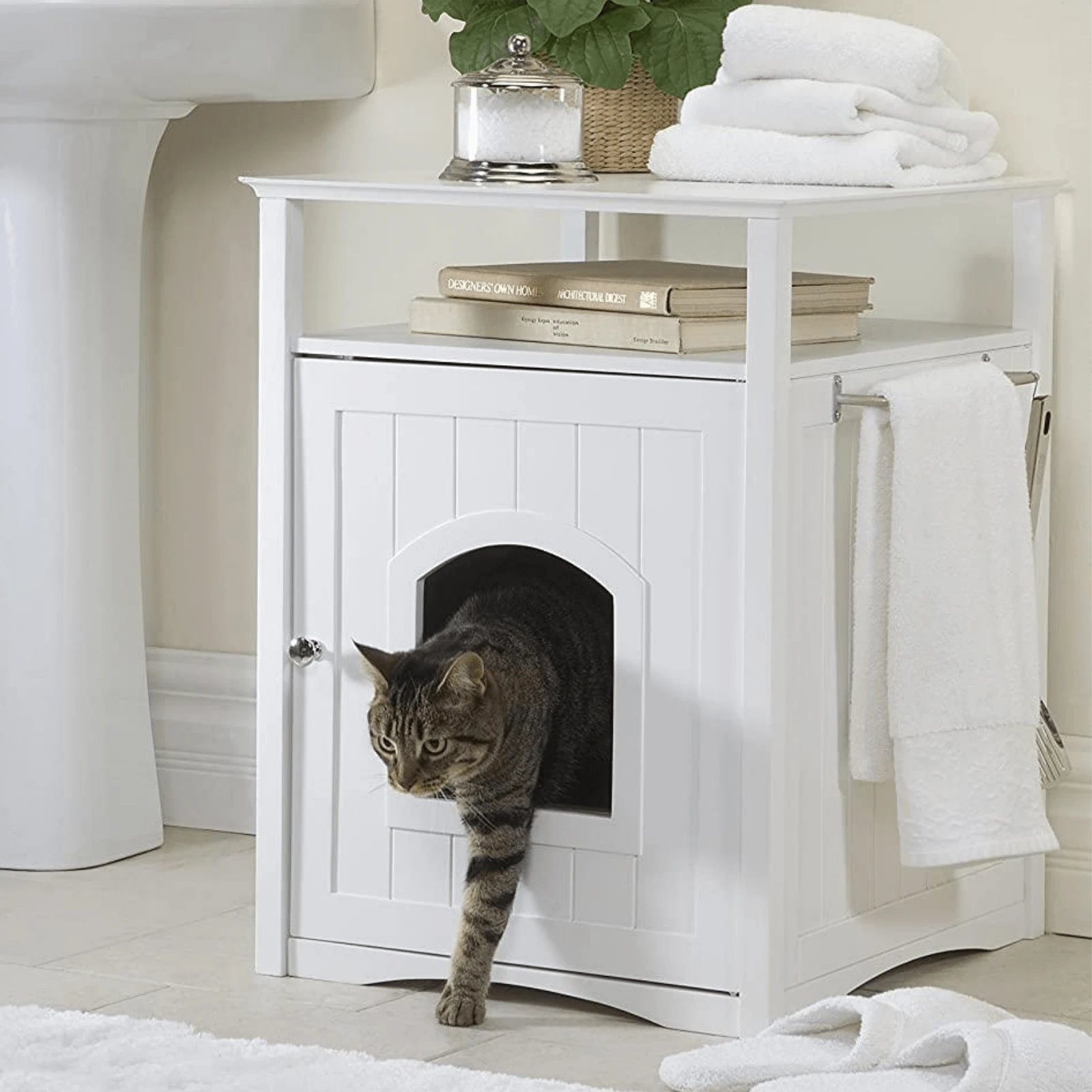 small cat litter pan hidden inside white cabinet